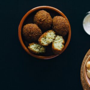 Overhead Shot of Fried Falafels Near a Hummus Dip